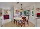 Bright dining area with white table, backyard views, and stylish lighting at 8388 Brad Oaks Cir, Las Vegas, NV 89123