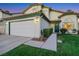 Inviting home featuring a two-car garage and lush green lawn at 8388 Brad Oaks Cir, Las Vegas, NV 89123