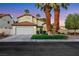 Charming two-story home with a well-manicured lawn and mature palm trees at 8388 Brad Oaks Cir, Las Vegas, NV 89123