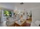 Open-concept living room area with a dining area, and a view to the backyard at 8388 Brad Oaks Cir, Las Vegas, NV 89123
