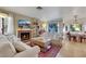 Inviting living room area with a fireplace, and an adjacent dining area at 8388 Brad Oaks Cir, Las Vegas, NV 89123