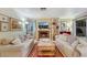 Comfortable living room with sofas, a fireplace, and decor with a view to the backyard at 8388 Brad Oaks Cir, Las Vegas, NV 89123