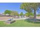 Community playground featuring picnic tables and play structures amidst mature trees at 8388 Brad Oaks Cir, Las Vegas, NV 89123