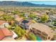 Aerial view of a neighborhood with well-maintained homes, mature trees, and a view of distant mountains at 8723 Melissa Meadows St, Las Vegas, NV 89131