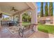 Charming backyard patio area with a seating, BBQ grill and a lush lawn at 8723 Melissa Meadows St, Las Vegas, NV 89131