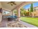 Inviting backyard featuring a covered patio, manicured lawn, and a hot tub at 8723 Melissa Meadows St, Las Vegas, NV 89131