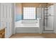 Bright primary bathroom with soaking tub and glass enclosed shower at 8723 Melissa Meadows St, Las Vegas, NV 89131