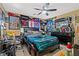 Eclectic bedroom featuring sports memorabilia, a fan, and dark furniture at 8723 Melissa Meadows St, Las Vegas, NV 89131