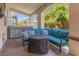 Relaxing covered patio with comfortable seating, string lights, and a view of the lush backyard at 8723 Melissa Meadows St, Las Vegas, NV 89131