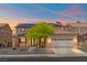 Two-story home features a neutral color scheme, large garage, and solar panels at 8723 Melissa Meadows St, Las Vegas, NV 89131