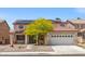 Two-story home features a neutral color scheme, large garage, and solar panels at 8723 Melissa Meadows St, Las Vegas, NV 89131