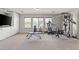 Bright carpeted home gym with windows, storage and workout equipment at 8723 Melissa Meadows St, Las Vegas, NV 89131