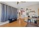 Office area with wood floors, accent wall, neutral paint, and large decorative screen at 8723 Melissa Meadows St, Las Vegas, NV 89131