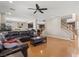 A view of an open-concept living room with a leather sofa, sleek floors, and a ceiling fan at 8723 Melissa Meadows St, Las Vegas, NV 89131