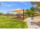 Community playground featuring a shaded play structure, grassy area, and walking path at 8723 Melissa Meadows St, Las Vegas, NV 89131