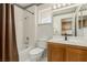 Clean bathroom with a shower-tub combination, framed mirror, and wood vanity at 8921 Signal Terrace Dr, Las Vegas, NV 89134
