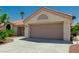 Charming single-story home featuring a desert landscape and a two-car garage at 8921 Signal Terrace Dr, Las Vegas, NV 89134