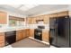 Traditional eat-in kitchen featuring black appliances, natural cabinets, and a window with view at 8921 Signal Terrace Dr, Las Vegas, NV 89134