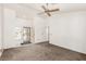 Spacious living room with neutral carpet, ceiling fan, and natural light at 8921 Signal Terrace Dr, Las Vegas, NV 89134