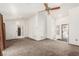 Open living room featuring neutral carpet, ceiling fan, and natural light at 8921 Signal Terrace Dr, Las Vegas, NV 89134