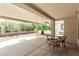 Inviting covered patio with outdoor seating and views of the backyard landscape at 8921 Signal Terrace Dr, Las Vegas, NV 89134