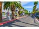Gated community entrance with palm trees and landscaping at 9050 W Tropicana Ave # 1075, Las Vegas, NV 89147