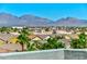 A panoramic view of mountains over the rooftops and palms of a neighborhood at 9050 W Tropicana Ave # 1075, Las Vegas, NV 89147