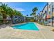 Community pool with lounge chairs and palm trees under a bright blue sky at 9050 W Tropicana Ave # 1075, Las Vegas, NV 89147