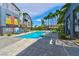 Community swimming pool with lounge chairs and palm trees at 9050 W Tropicana Ave # 1075, Las Vegas, NV 89147