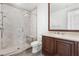 Beautiful bathroom featuring a glass shower, wood cabinets, tile accents, and modern fixtures at 9101 Alta Dr # 1604, Las Vegas, NV 89145