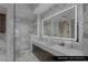 Modern bathroom featuring a walk-in shower, sleek vanity, and elegant marble finishes at 9101 Alta Dr # 1604, Las Vegas, NV 89145