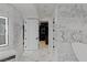 Elegant bathroom featuring marble walls and floors, a walk-in shower, and a double vanity at 9101 Alta Dr # 1604, Las Vegas, NV 89145