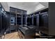 Large closet with custom dark wood shelving and display cases at 9101 Alta Dr # 1604, Las Vegas, NV 89145