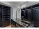 Spacious walk-in closet featuring custom shelving, drawers, and a central display island at 9101 Alta Dr # 1604, Las Vegas, NV 89145