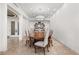 Elegant dining room features a stylish chandelier, marble floors, and large oval wood table for sophisticated dining at 9101 Alta Dr # 1604, Las Vegas, NV 89145