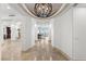 Open hallway with marble flooring leading to living spaces, complemented by a decorative ceiling fixture at 9101 Alta Dr # 1604, Las Vegas, NV 89145