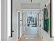 Bright hallway with elevator leading to an open concept living space with art at 9101 Alta Dr # 1604, Las Vegas, NV 89145