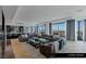 Open-concept living room boasts expansive windows, bar, and a comfortable seating arrangement with city views at 9101 Alta Dr # 1604, Las Vegas, NV 89145