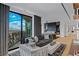 Spacious living room with city views, stylish furniture, and access to a balcony at 9101 Alta Dr # 1604, Las Vegas, NV 89145