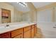 Bathroom features double sinks, tub, shower and natural light through the window at 9398 Sailing Water Ave, Las Vegas, NV 89147