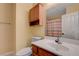 Bathroom with a white vanity, an overhead cabinet, a toilet, and a shower/tub combination at 9398 Sailing Water Ave, Las Vegas, NV 89147