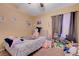 Bedroom with colorful decor, a cozy bed, personal artwork, and a window with natural light at 9398 Sailing Water Ave, Las Vegas, NV 89147