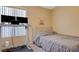 Cozy bedroom featuring a comfortable bed, a desk, and modern electronics for a functional and inviting space at 9398 Sailing Water Ave, Las Vegas, NV 89147