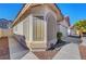 A single story house with a large bay window, desert landscaping and an attached two-car garage at 9398 Sailing Water Ave, Las Vegas, NV 89147