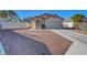 Single-story home featuring a two-car garage and low-maintenance desert landscaping at 9398 Sailing Water Ave, Las Vegas, NV 89147