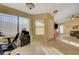 Bright living room featuring tile floors, several windows and access to other areas of the home at 9398 Sailing Water Ave, Las Vegas, NV 89147