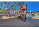 Backyard features a large wooden playground set with swings, slide and climbing at 9398 Sailing Water Ave, Las Vegas, NV 89147