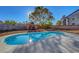 Backyard features a pool, mature tree and playground for outdoor fun at 9398 Sailing Water Ave, Las Vegas, NV 89147