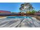 Backyard features a pool, lush greenery and playground for outdoor fun at 9398 Sailing Water Ave, Las Vegas, NV 89147