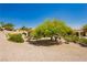 Picturesque backyard showcasing desert landscaping, mature trees, and a peaceful setting for outdoor relaxation at 9525 Salem Hills Ct, Las Vegas, NV 89134